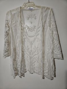 An airy open front very elegant sheer overlay jacket.  This lovely sheer jacket has a beautiful all over embroidery with 3/4 sheer sleeves and scalloped trim.  This can definitely be dressed up or down.   Thank you kindly for visiting SGI! Please check out other items listed on our site. https://www.etsy.com/shop/ShesgotitbySky Spring Wedding Lace Outerwear, Summer Wedding Long Sleeve Outerwear, Embroidered Lace Long Sleeve Outerwear, All Over Embroidery, Sheer Jacket, Mesh Jacket, Floral Overlay, Sheer Overlay, Scalloped Trim