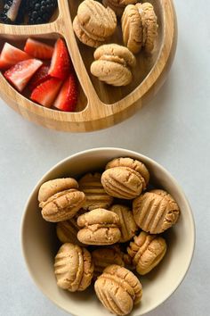 two bowls filled with fruit and nuts next to each other