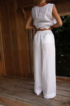 The Lottie Linen Pants feature an elasticised waist with a drawcord, side and back pockets, and a relaxed wide leg. Styled here with our cropped Nat top and scolloped Roma Top. Features Side PocketsElasticised wide waistband with frill hemWide LegsCropped LengthDesigned to be worn mid waistWorn here with the linen IBIZA Tube Top Fabric Pure Linen Cold gentle machine wash. Do not tumble dry. Colours Black Linen Natural Linen Natural Stripe (this fabric is COTTON) White Linen (*white linen not lin Bath Wedding, Sheer Pants, Womens Dress Tops, Homewear Woman, Studio Color, White Linen Pants, Linen Shirt Men, Linen White, Outdoor Home