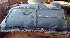 an old pair of jeans that has been turned into a pillow with holes in it