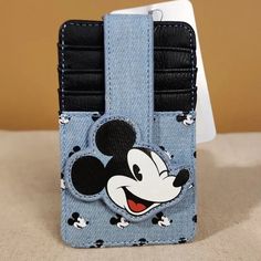 When Traveling Beyond Toontown, Put Your Credit Cards And Cash In This Compact Mickey Mouse Wallet With Denim Accents! Make This The Perfect Gift For That Special Someone... Or Just Treat Yourself! * * * * Features * * * * * Size 3" X 5" * Faux Leather & Jean Exterior * 1 Id Slot * 4 Card Slots With Flap Over Snap Closure * By Disney * New With Tags Add This Cute Mickey Cardholder To Your Favorite Bag! Trendy Blue Card Holder With Card Slots, Green Bay Packers Shirts, Faux Leather Jeans, Cardholder Wallet, Card Holder Wallet, Disney Mickey Mouse, Denim Jean, Green Bay, Disney Mickey