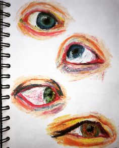 an image of three different colored eyes on a notebook page with the eyeball drawing in it