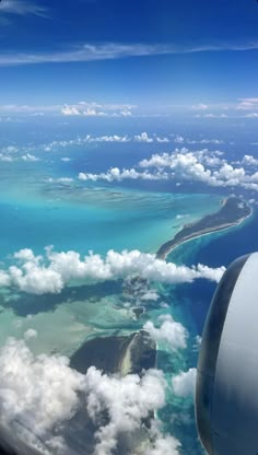 the view from an airplane looking out at some water and land in the ocean below