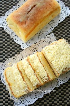 two slices of bread sitting on top of doily next to another piece of bread