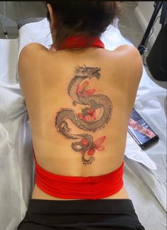 a woman with a dragon tattoo on her back