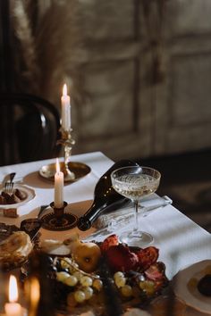 the table is set with food and candles