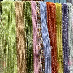 many different colored beads on display in a store