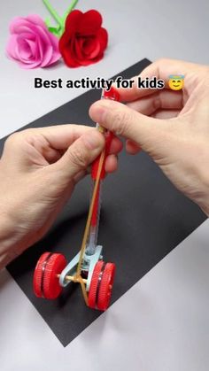 someone is making a toy car out of construction paper and plastic wheels, with the words best activity for kids