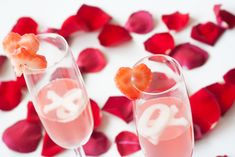 two champagne flutes filled with rose petals and topped with orange slices, garnished with the number 30