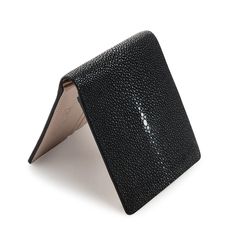 Genuine White Pearl Black Polished Stingray Leather Wallet  Features genuine stingray leather for exterior and cowhide leather for interior;  Bi-fold design;  Size closed: 4 ½” x 3 6/8” (approx 11.5 cm x 9.5 cm);  Award-winning product in the handicraft category (Thailand);  2 clear ID slots, 10 credit card slots, 2 bill compartments;  Handmade product.   Sleek, compact, and rugged, this White Pearl Black Polished Stingray Leather Wallet is an ideal money accessory. It provides plenty of slots t Leather Bifold Card Holder For Evening, Black Textured Leather Card Holder, Luxury Textured Leather Bifold Card Holder, Black Textured Leather Rectangular Wallet, Textured Leather Bifold Card Holder, Luxury Wallets With Grained Texture For Formal Occasions, Rectangular Leather Wallet With Pebbled Texture, Luxury Leather Wallet With Grained Texture, Formal Leather Wallet With Grained Texture