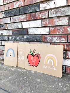 three cardboard signs with the words miss you, miss me, and rainbow painted on them