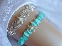 two bracelets on top of each other with pearls and stars attached to the wrist