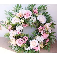 a wreath with pink and white flowers on it