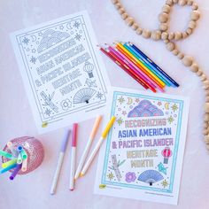 an assortment of coloring supplies including pencils, markers and beads on a pink surface