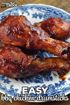 two pieces of chicken on a blue and white plate with the words easy bbq chicken drumsticks