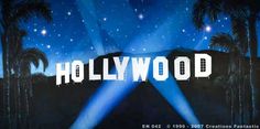 the hollywood sign is lit up with blue lights and palm trees in the background,