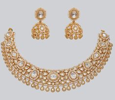 Gold Finish Elegant Kundan Polki Necklace Set Zevar By Geeta - Fabilicious Fashion Gold Chandbali-shaped Jeweled Bridal Necklace, Gold Chandbali Bridal Necklace Jeweled, Gold Kundan Necklace With Elegant Design, Gold Chandbali Bridal Necklace With Jeweled Details, Elegant Gold Kundan Necklace With Stone Work, Elegant Gold Kundan Necklace With Meenakari, Gold Kundan Jeweled Bridal Necklace, Gold Kundan Bridal Necklace With Jewels, Elegant Jeweled Gold Temple Necklace