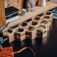 several wooden boxes sitting on top of a table next to some books and other items