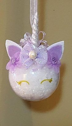 a glass ornament with a unicorn face on it