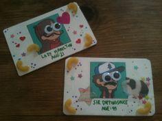 two coasters with cartoon characters on them are sitting on a table together, one is wearing glasses and the other has a hat