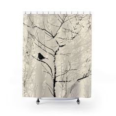 a bird perched on top of a tree in the snow shower curtain set, with black and white trees behind it