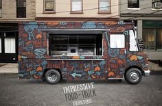 the food truck is painted with graffiti on it