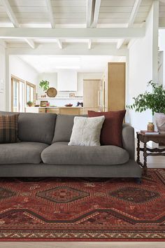 a living room filled with furniture and a rug