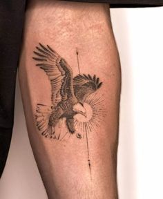 an eagle tattoo on the leg of a man