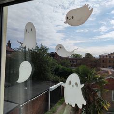 some ghost decorations hanging from the window