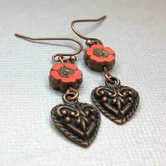 Coral pink red flower beads sit atop small rustic copper hearts. These beautiful Czech glass flower beads feature multiple shades of luscious coral color. Small and lightweight, perfect for any occasion. Great gift for women and girls.  Artisan glass beads produced in small quantities in Czech Republic  Hypoallergenic ear wires (nickel and lead free). Select ear wire style at checkout.  A gift for you or someone special, earrings are carded and in an organza bag. Link back to my shop: https://ww Ivory Earrings, Czech Glass Jewelry, Vintage Jewelry Repurposed, Coral Flower, Reno Nv, Rustic Jewelry, Handmade Jewelry Gift, Funky Jewelry, Flower Beads