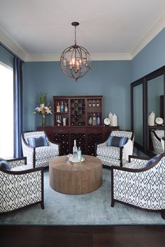 a living room filled with furniture and a chandelier