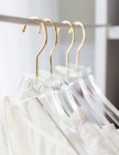 some clothes hangers that say bride on them