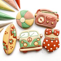 decorated cookies are arranged in the shape of vw campervans and surfboards