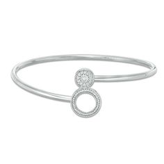 From the Convertibilities Collection, this two-in-one diamond flex bangle elevates your attire. Crafted in sterling silver, this versatile look features a pair of coordinating elements that fit together - a diamond-lined circle frame and a sparkling diamond-adorned circle outline. Wear the bracelet closed as a bangle or open as a bypass design - it's your style your way. Radiant with 1/5 ct. t.w. of diamonds and a bright polished shine, this flex bangle measures 7.0 inches in circumference. Silver Bangle With Pave Setting, Silver Bangle With Pave Setting In Fine Jewelry Style, Silver Bangle With Pave Setting Fine Jewelry, Silver Bangle With Brilliant Cut In Timeless Style, Modern Silver Diamond Bracelet With Pave Setting, Timeless Silver Bangle With Brilliant Cut, Silver Stackable Diamond Bracelet Fine Jewelry, Modern Silver Diamond Bracelet With Single Cut Diamonds, Sterling Silver Diamond Accent Bangle Bracelet