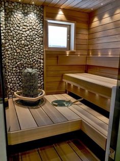 a wooden sauna with stone walls and benches