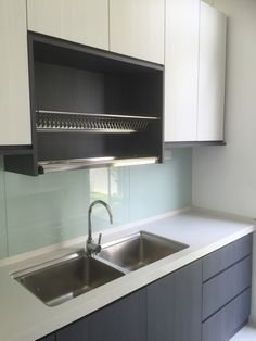 an empty kitchen with white cabinets and stainless steel sink faucet above the counter