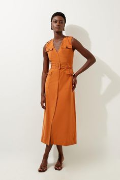 Prepare To Turn Heads From Sunrise To Sunset In Our Safari Inspired Dress, With A Pocketed Design Perfect For Days On The Go, And A Silhouette That Skims The Figure. Styles Well With Anything, From Heeled Ankle Boots To Strappy Sandals For Looks That Will See You From Holiday Days To Evenings Out. Tailored Safari Cargo Pocket Belted Midi Dress High Quality Tailored Design Ultra Flattering Fit And Flare Silhouette V Neckline Statement Pocket Design Shirt Style Bodice Pocket Features Belted Waistl Brown Workwear Dress With Pockets, Belted Brown Dress For Work, Chic Orange Midi Dress For Work, Orange V-neck Midi Dress For Work, Spring Camel Dress, Brown Sleeveless Midi Dress For Work, Cargo Dress Outfit, Explorer Dress, Hen Do Outfits