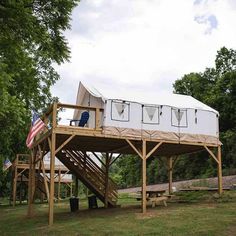 a white tent sitting on top of a wooden deck