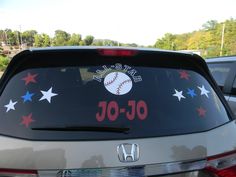 the back of a car with a baseball decal on it