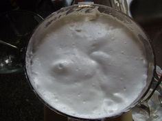 a glass filled with liquid sitting on top of a counter