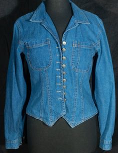 This is a rare 1980's cotton denim boutique Stonebridge jean top that's decorated with buttons in such a western manner. This jean top is a unique and rare find in a medium blue wash cotton denim that it so wild west prairie in character. This made in U.S.A. denim top in great shape with more signs of wear/fade/use and theres a little wearing that's shown in the last close up photo. It's made of 100% cotton with a great denim fabric. You'll love it. It's a marked a size 8 and flat measurements a Vintage Cotton Denim Top With Button Closure, Vintage Washed Blue Denim Top With Button Closure, Vintage Long Sleeve Denim Top With Button Closure, Vintage Blue Button-up Denim Top, Denim Boutique, Vintage Denim Blue Button-up Top, 70s Denim, Vintage Western Wear, Jean Shirt