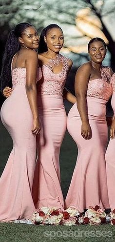 three women in pink dresses posing for the camera