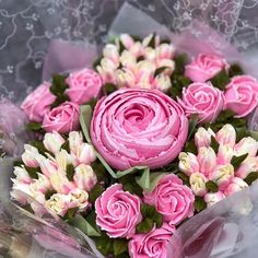 a bouquet of pink flowers sitting on top of a table