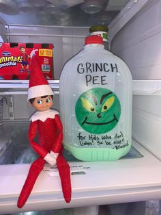 an elf is sitting next to a bottle of ginch pie for kids who don't