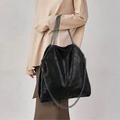 Black Luxe Soft Vegan Leather Chain Shoulder Tote Bag, Faux Leather , Ships In 7-8 Days Edgy Party Bags With Chain Strap, Edgy Bags With Chain Strap For Daily Use, Edgy Black Bag With Chain Detail, Black Soft Leather Shoulder Bag For Night Out, Evening Shoulder Bag With Chain Strap In Faux Leather, Edgy Shoulder Bag With Chain Strap, Evening Faux Leather Shoulder Bag With Chain Strap, Edgy Shoulder Bag With Chain Strap For Everyday, Black Shoulder Bag With Chain In Tote Shape