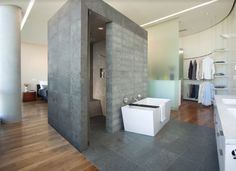 a bathroom with two sinks and a bathtub in the middle of it, next to a large mirror