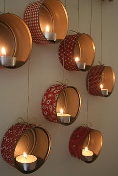 several hanging tin canisters with candles on them