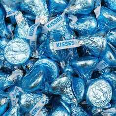 a pile of blue chocolate candies sitting on top of each other in wrappers