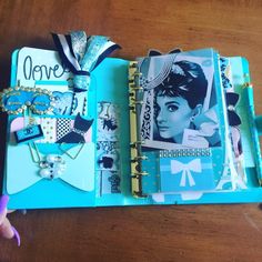 an open book with many different items on it, including hair clips and necklaces