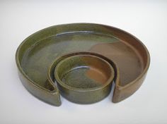 three pieces of green pottery sitting on top of each other